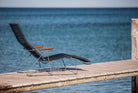 Black HOUE CLICK sunlounger on wooden dock overlooking the ocean