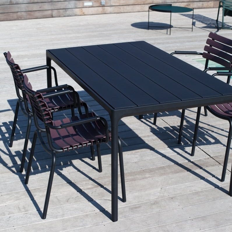Black dining table with four black dining chairs