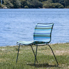 Blue striped outdoor chair by water