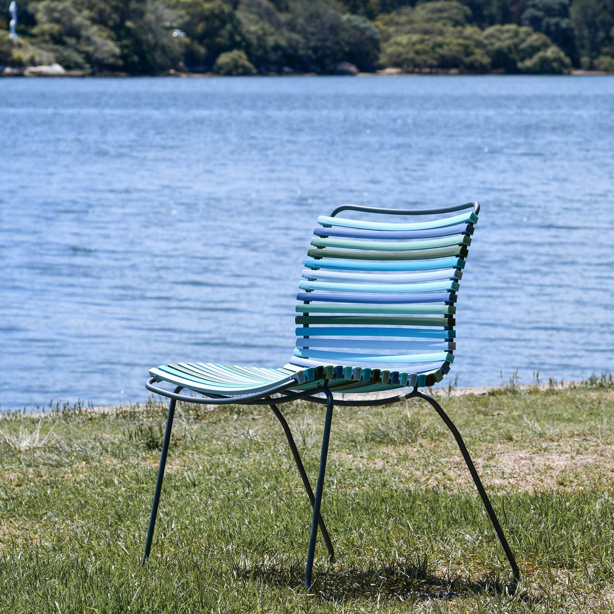 Blue striped outdoor chair by water