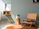 Modern living room with woven chair and plant