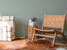 Leather chair and storage trunks in room