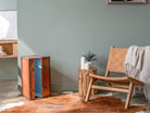 Interior scene with trunk, chair, and rug