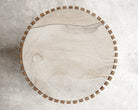 Round wooden side table with decorative edge