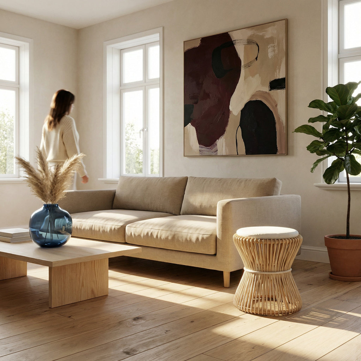 Modern living room with a beige sofa, wooden coffee table, and abstract art on the wall.