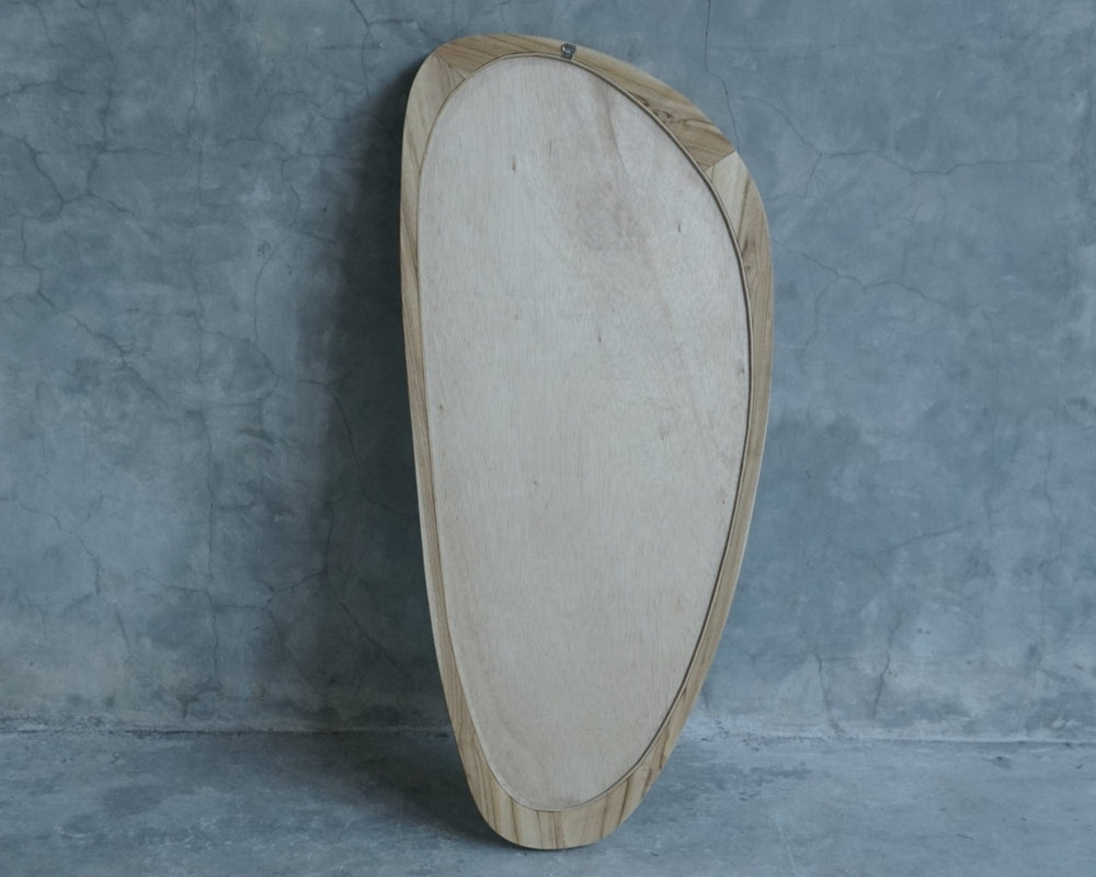 Modern wooden framed mirror against gray wall