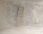 Wooden ladder against concrete wall