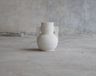 White textured vase with handles.