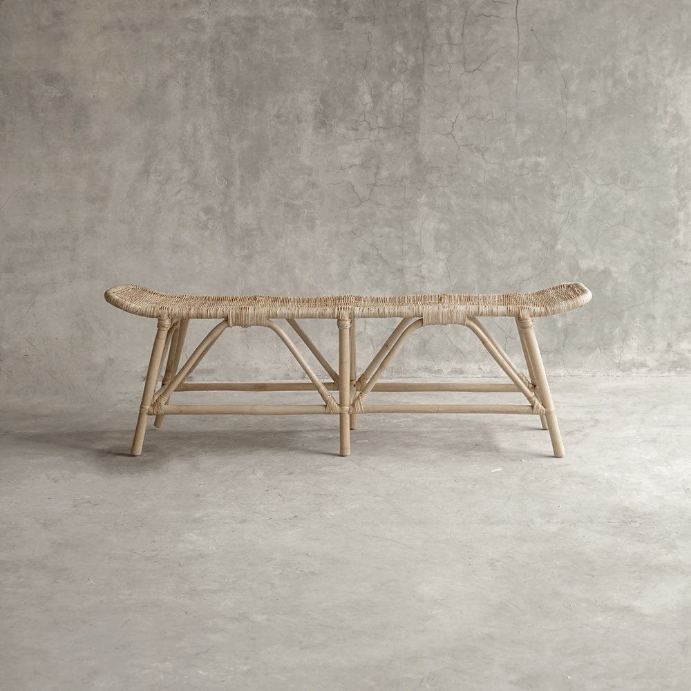 Woven rattan bench on concrete background