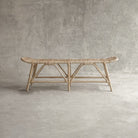 Woven rattan bench on concrete background