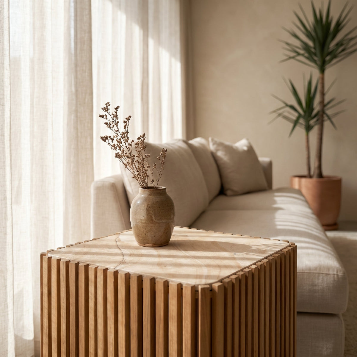 Living room with a wooden coffee table, beige sofa, and potted plant.