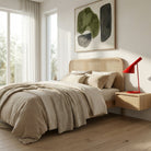 Modern bedroom with a bed, nightstand, and wall art