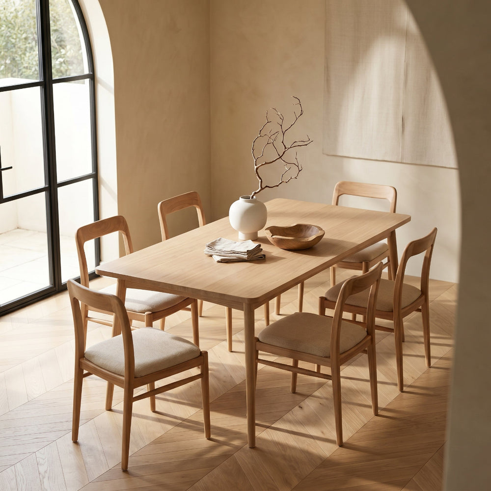 Dining room with wooden table and chairs in a well-lit room.