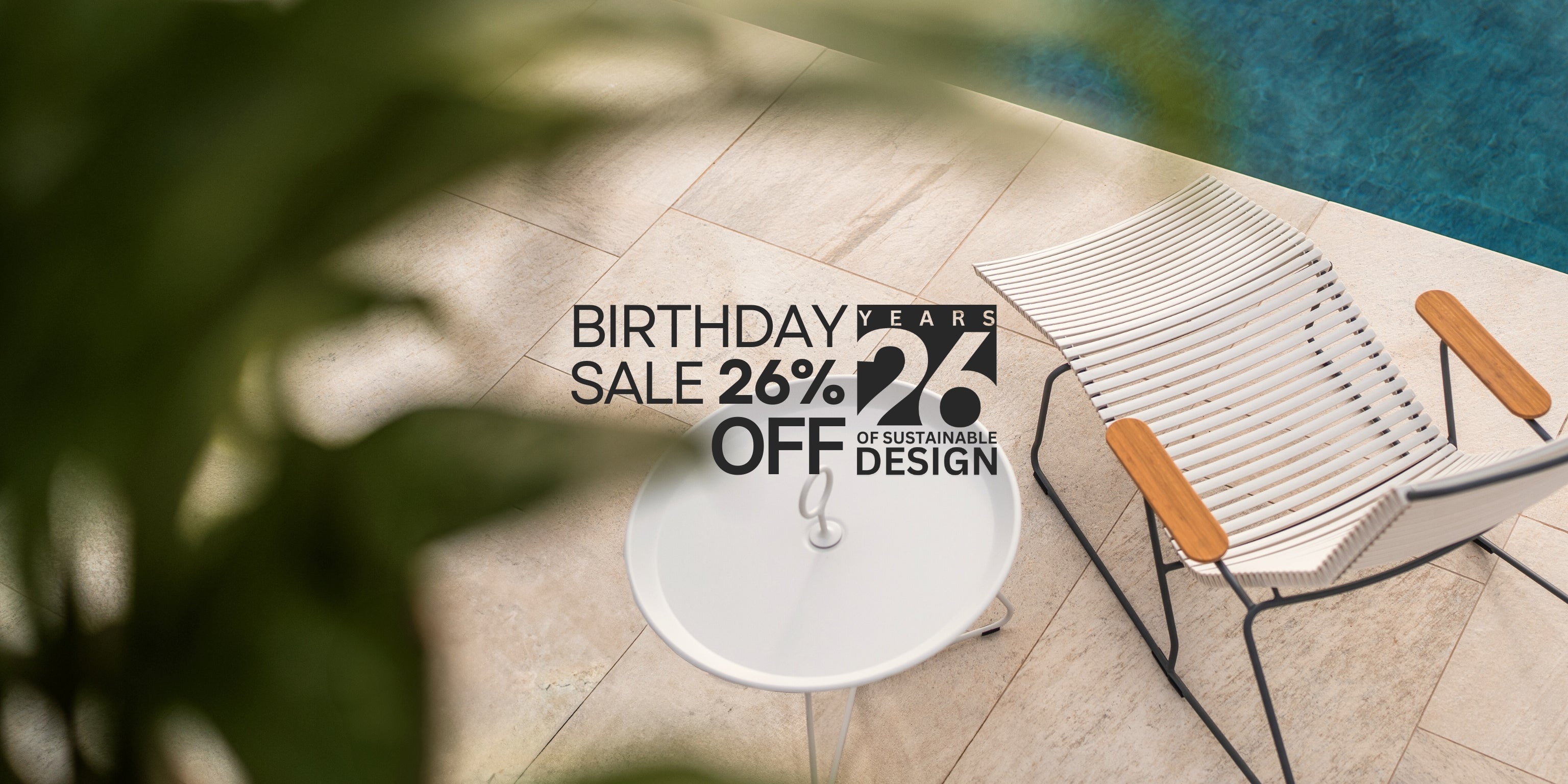 Chair by a pool with a birthday sale promotion overlay