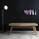 Modern bench, floor lamp, and art on black wall
