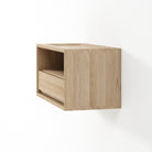 Wooden wall-mounted shelf with a drawer on a white background