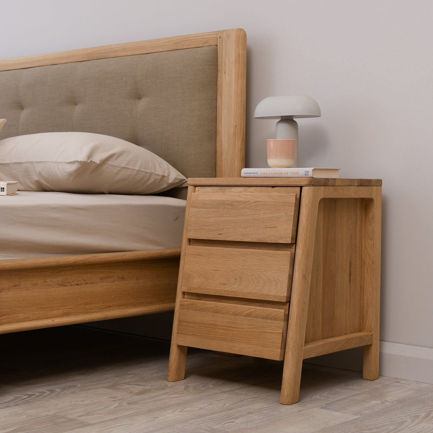 Oak nightstand KCC41OKCC26O with three drawers and lamp.