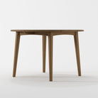 Wooden round table with tapered legs