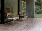 Two wooden chairs on a deck