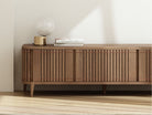Wooden media console with lamp and books