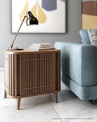KOPPARSidetable with lamp and books next to blue sofa