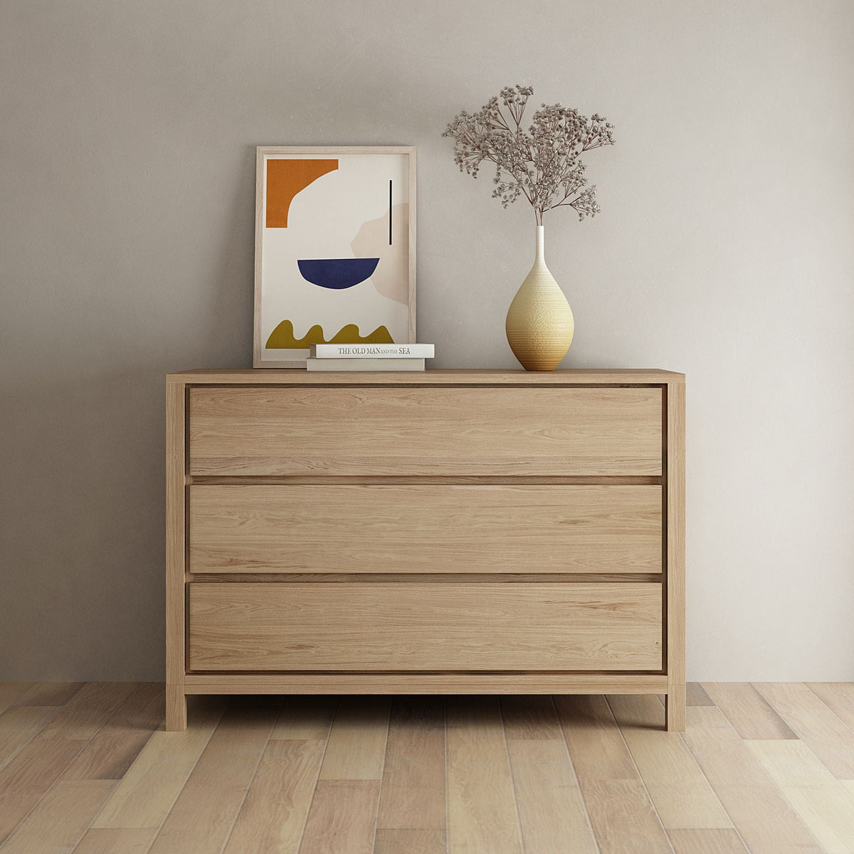 Modern wooden dresser with art and vase.