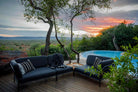 Sooty grey HOUE outdoor sofa set by pool at sunset