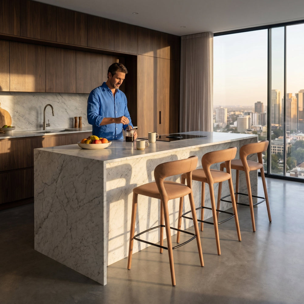 Man preparing food in a modern kitchen with a cityscape view