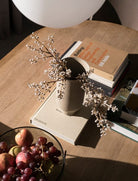 MENU Echasse vase with flowers on books