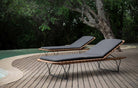 two lounge chairs by pool