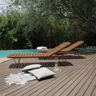 Wooden chaise lounges by pool