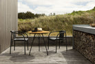 NAMI Dining set with black armrests, bamboo table, and outdoor setting.