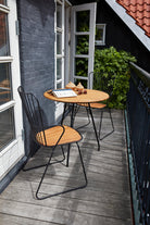 PAON black dining table with bamboo detail on balcony