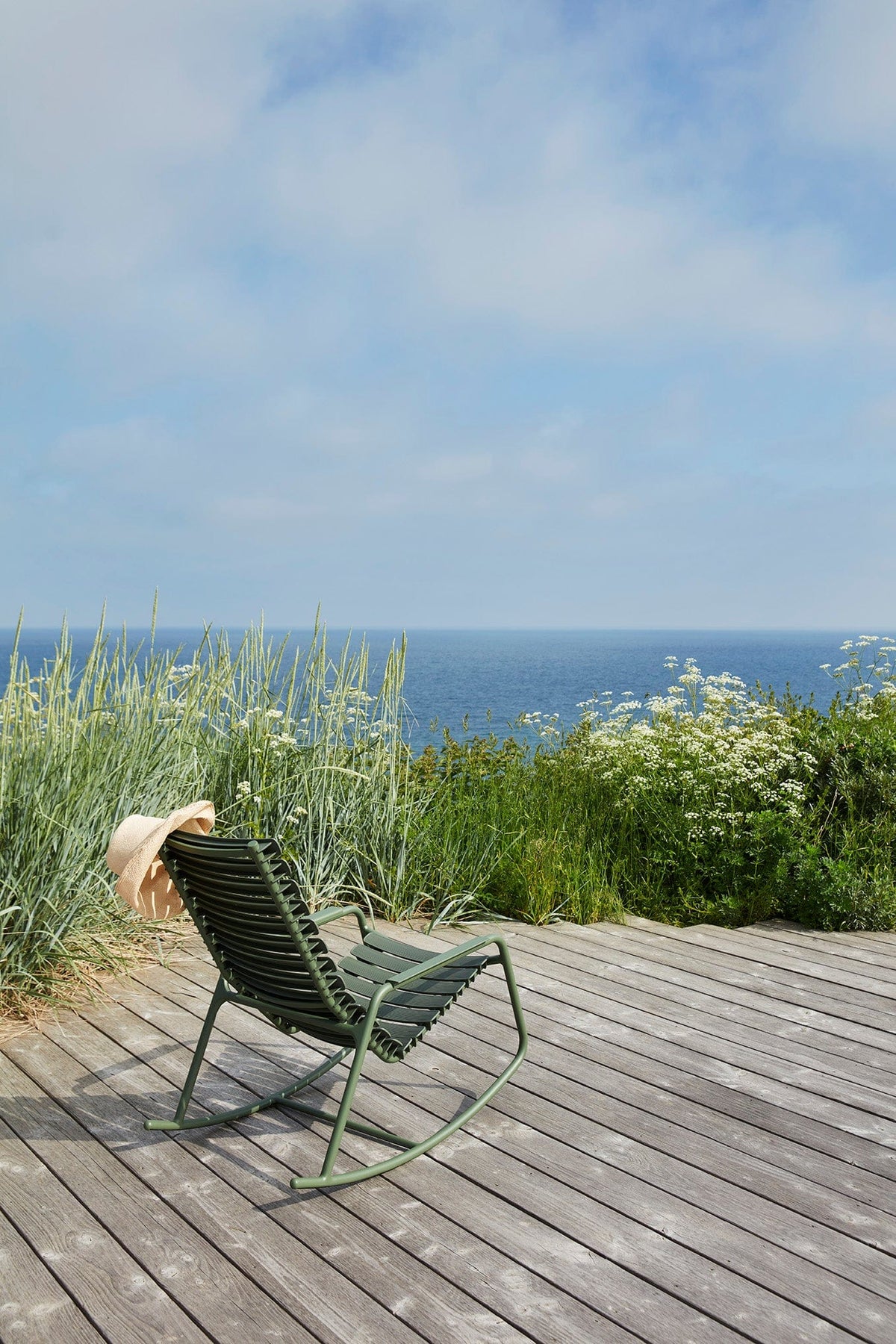 ReCLIPS olive green rocking chair by HOUE on deck overlooking ocean