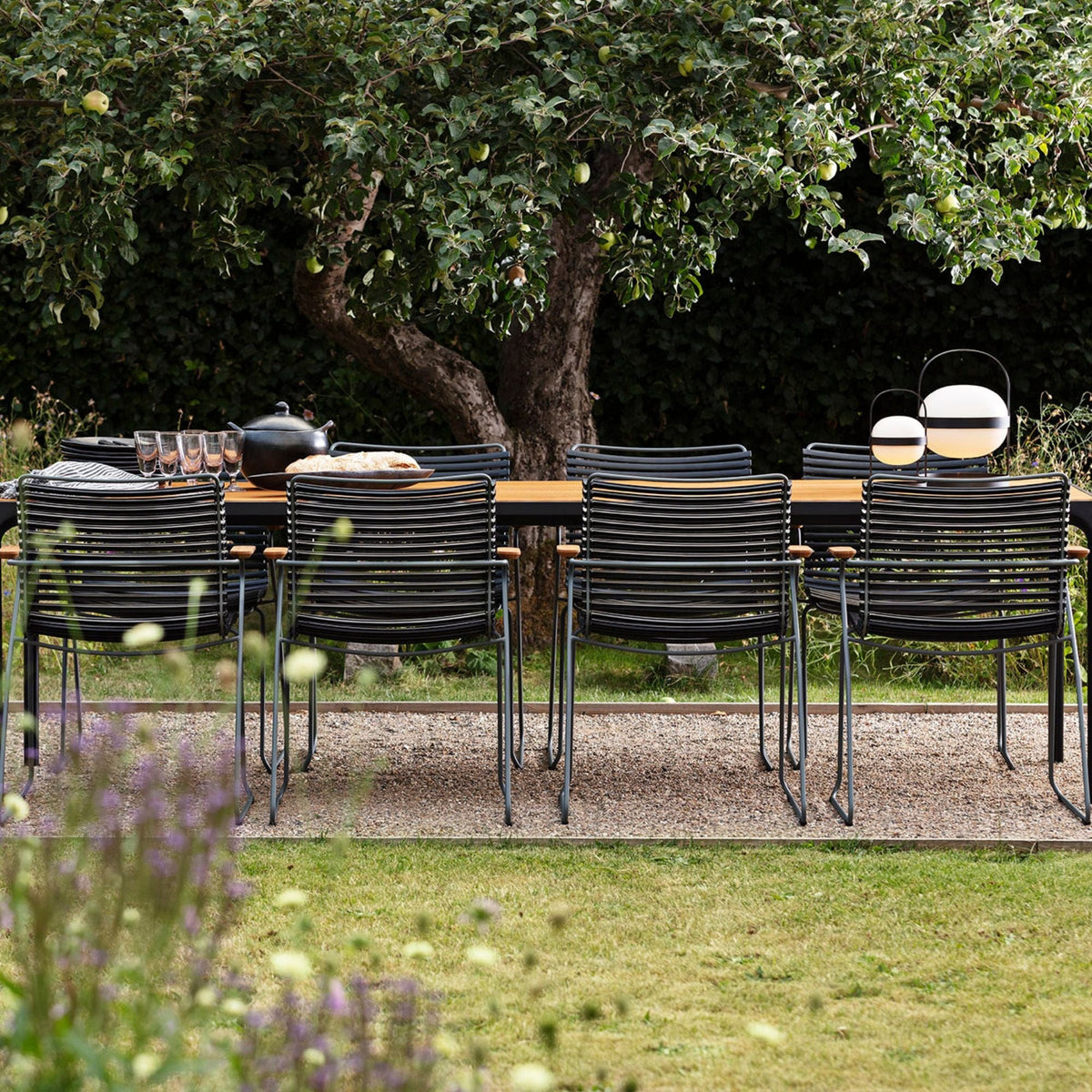 Black click four-table set with chairs under tree