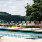 Colorful armless chairs by a pool