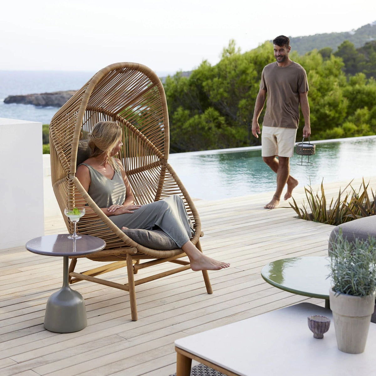 Hive chair on patio with person near pool