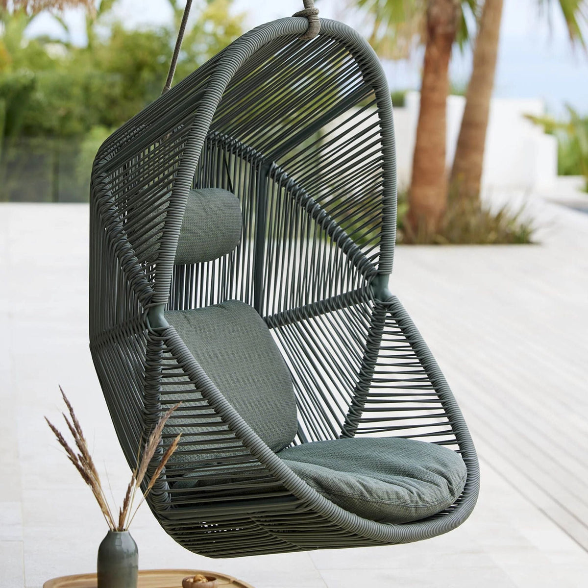 Grey hanging Hive chair outdoors