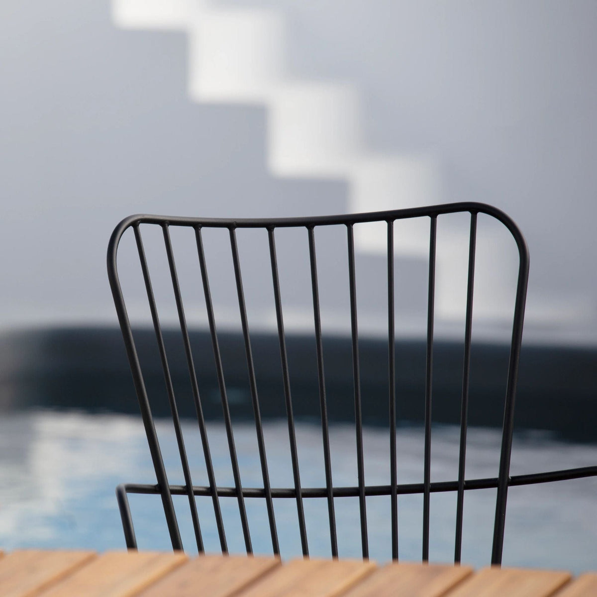 Paon Bar Chair with Cushion, back view by pool
