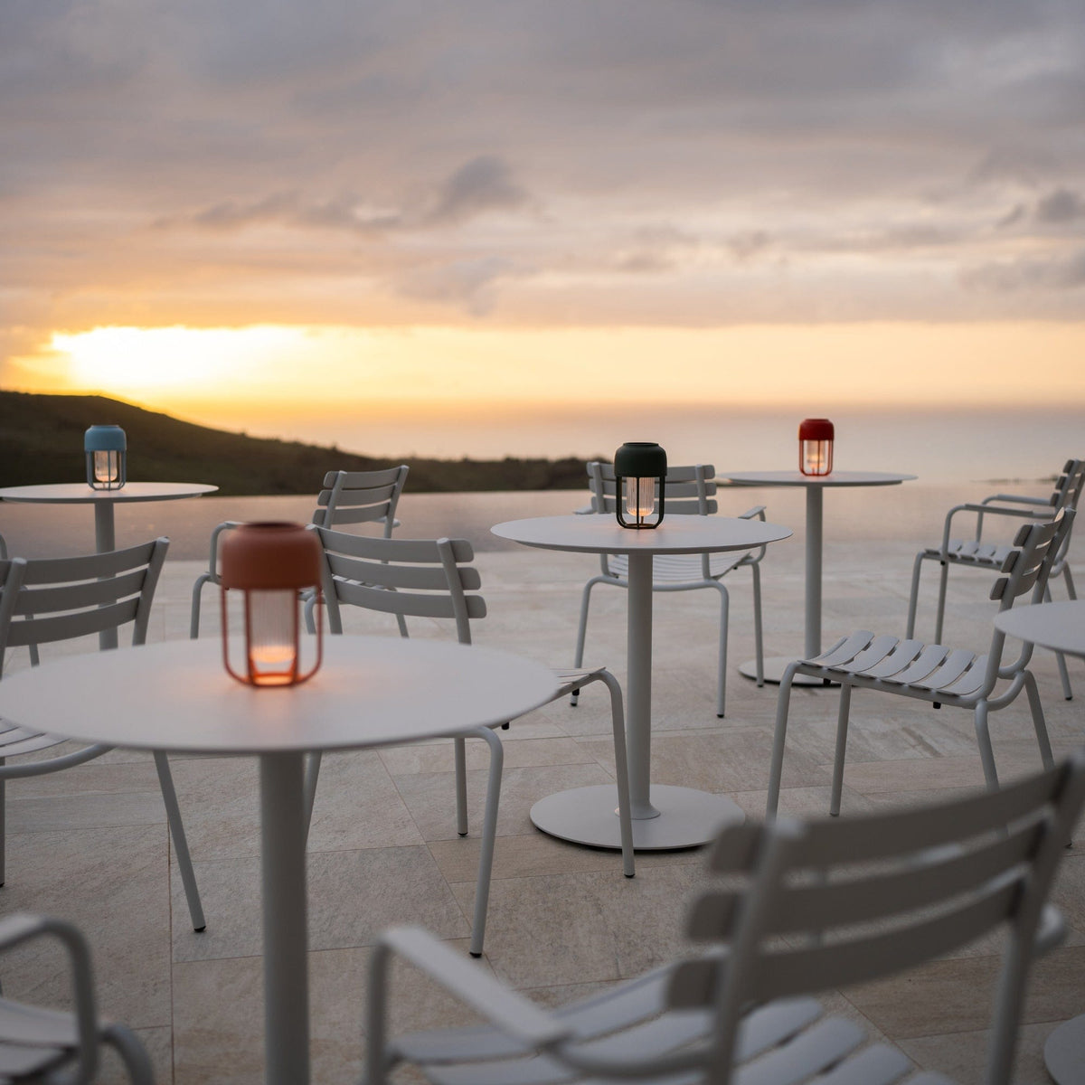 Pico Alua white lanterns on outdoor tables at sunset