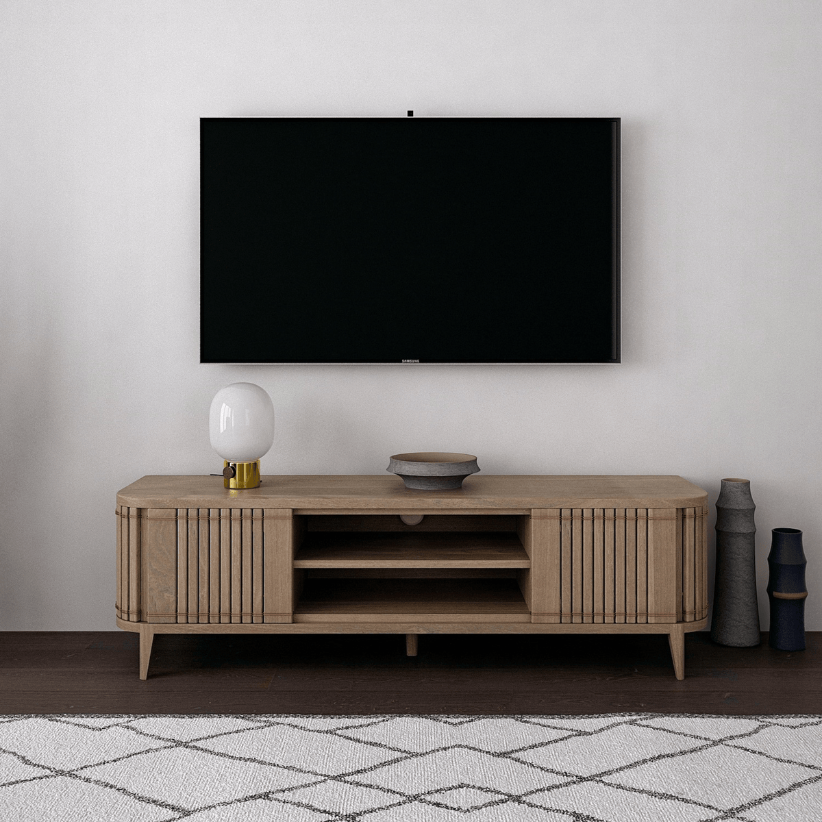 TV and entertainment stand against a white wall.