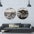 Black and white round landscape art above sofa