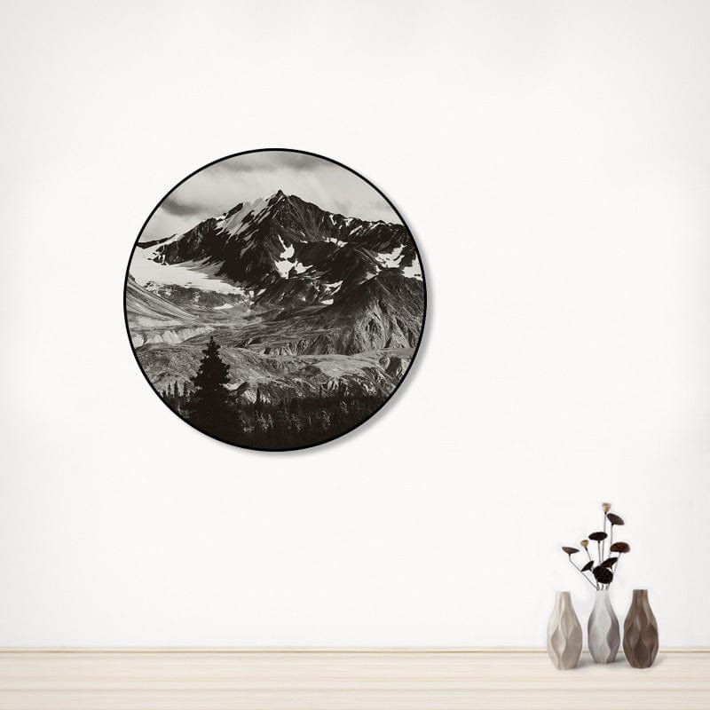 Black and white mountain landscape in a round frame.