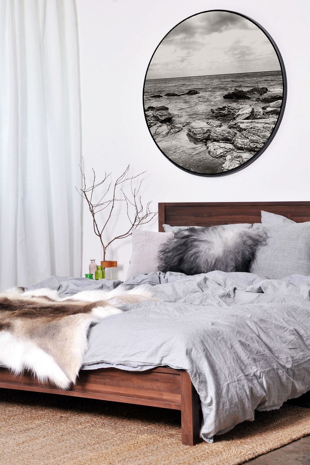 Bedroom with framed black and white seascape