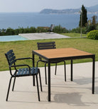 Black dining chairs with bamboo table outdoor