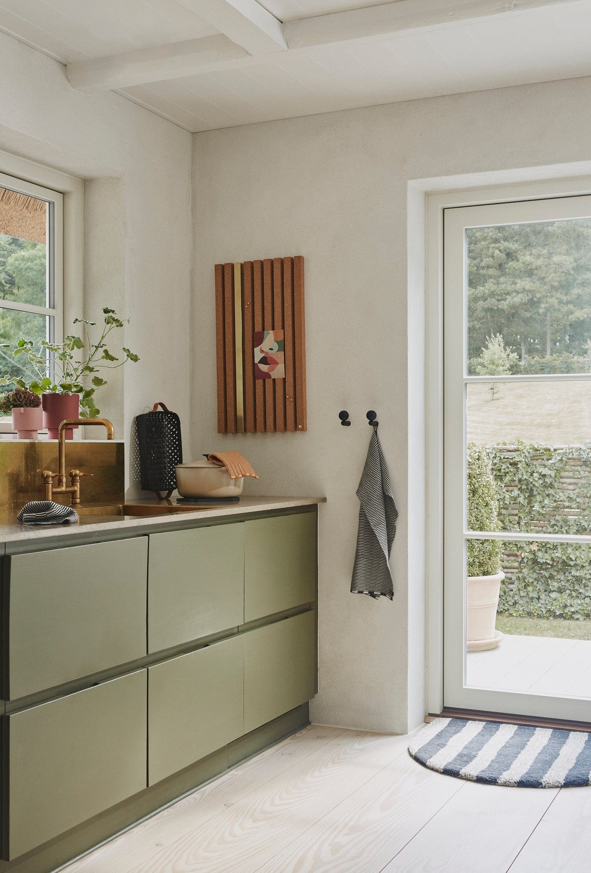 Kitchen with olive cabinets and Sienna Rose decor