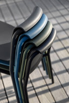 Stacked NAMI chairs in various colors