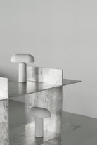 Modern white mushroom lamps on metal shelves