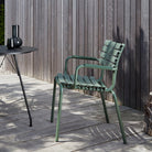 Green outdoor dining chair made from recycled plastic.