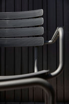 Closeup of ReCLIPS chair against dark wood.